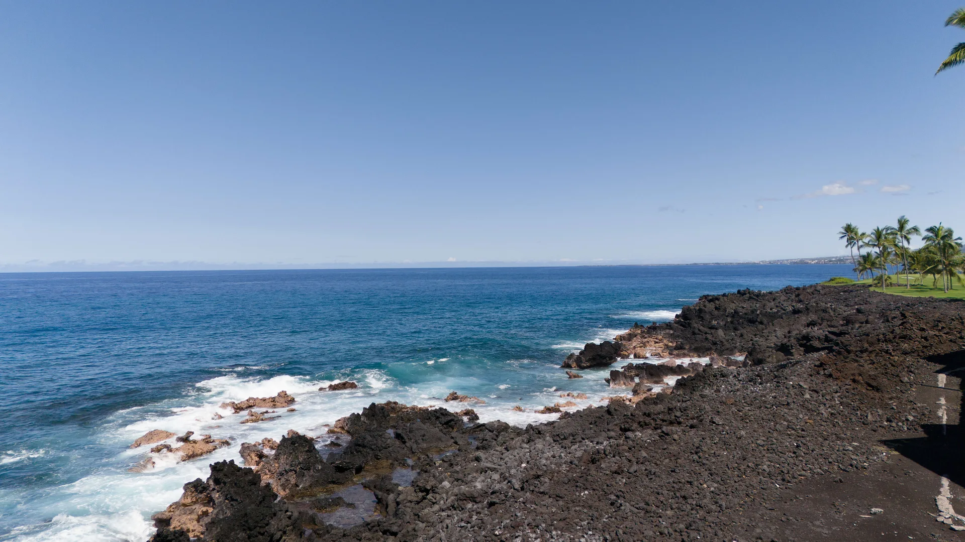Coastline with lava rocks and blue water