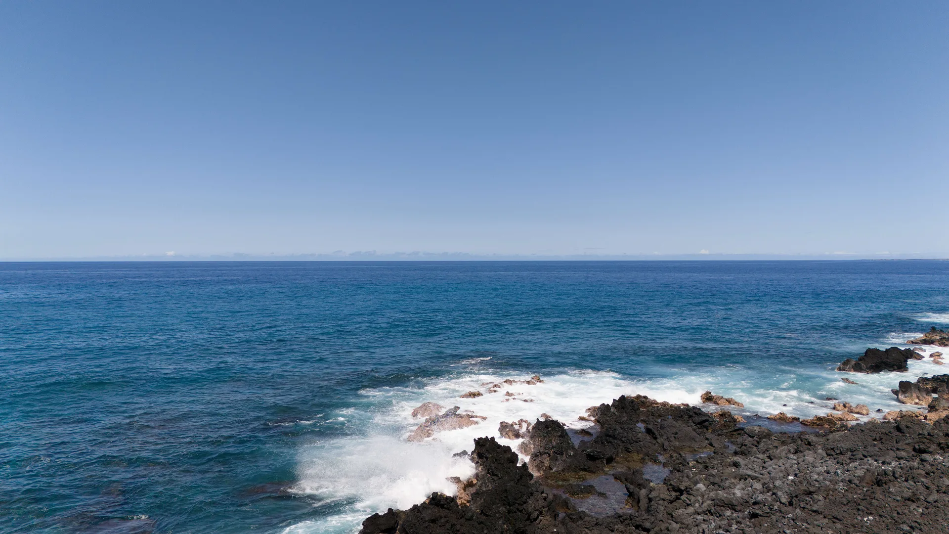 Ocean and lava rocks from above