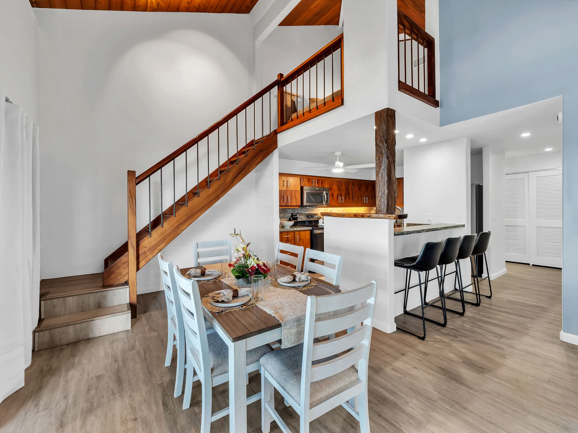 Dining table with staircase and bar seating