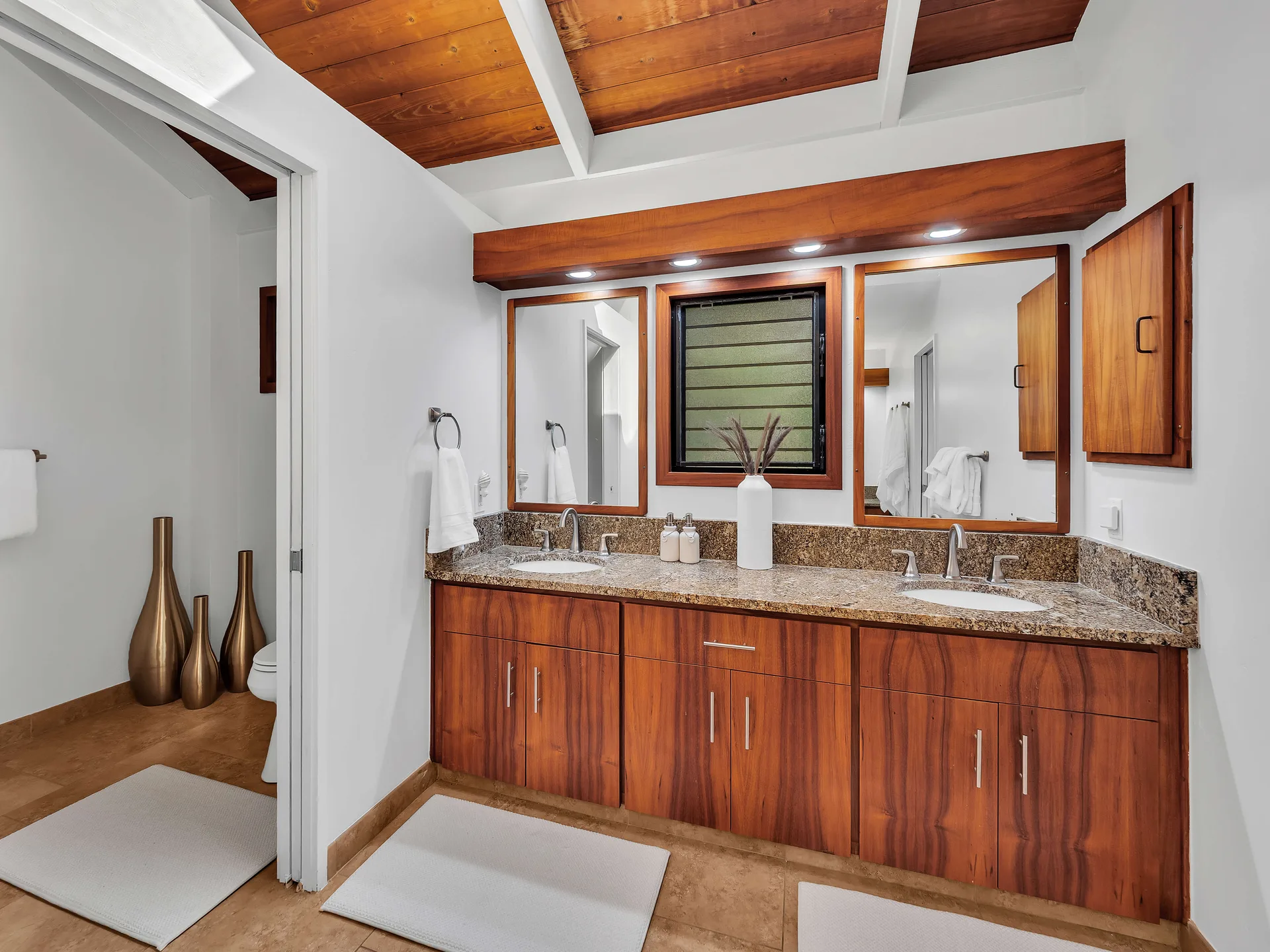 Master bathroom with double vanity and wood ceiling