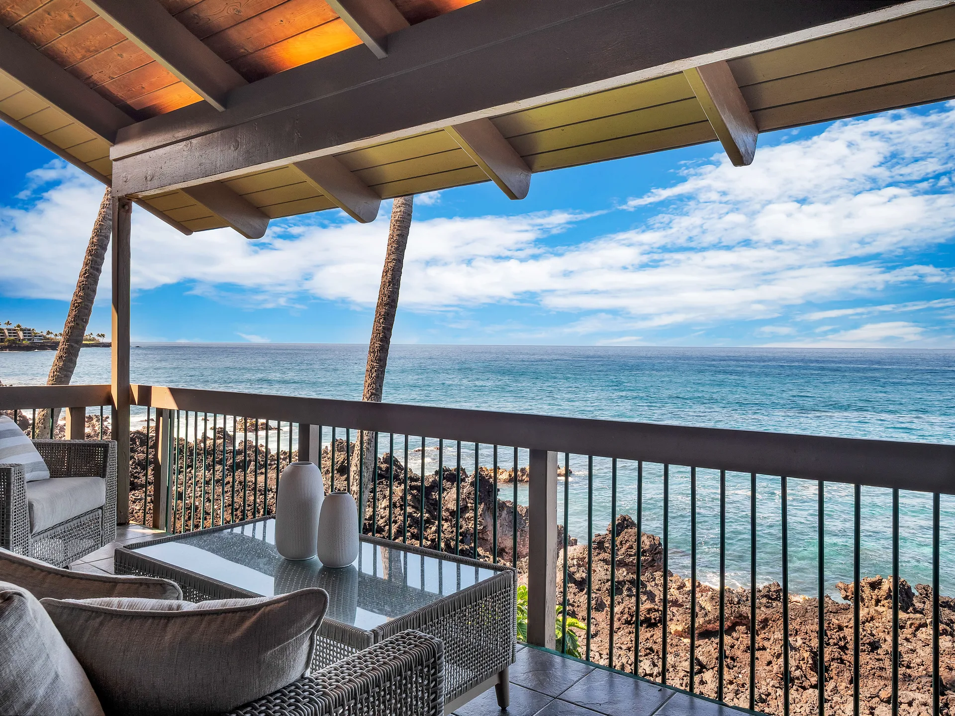 Covered lanai with ocean view and lounge furniture