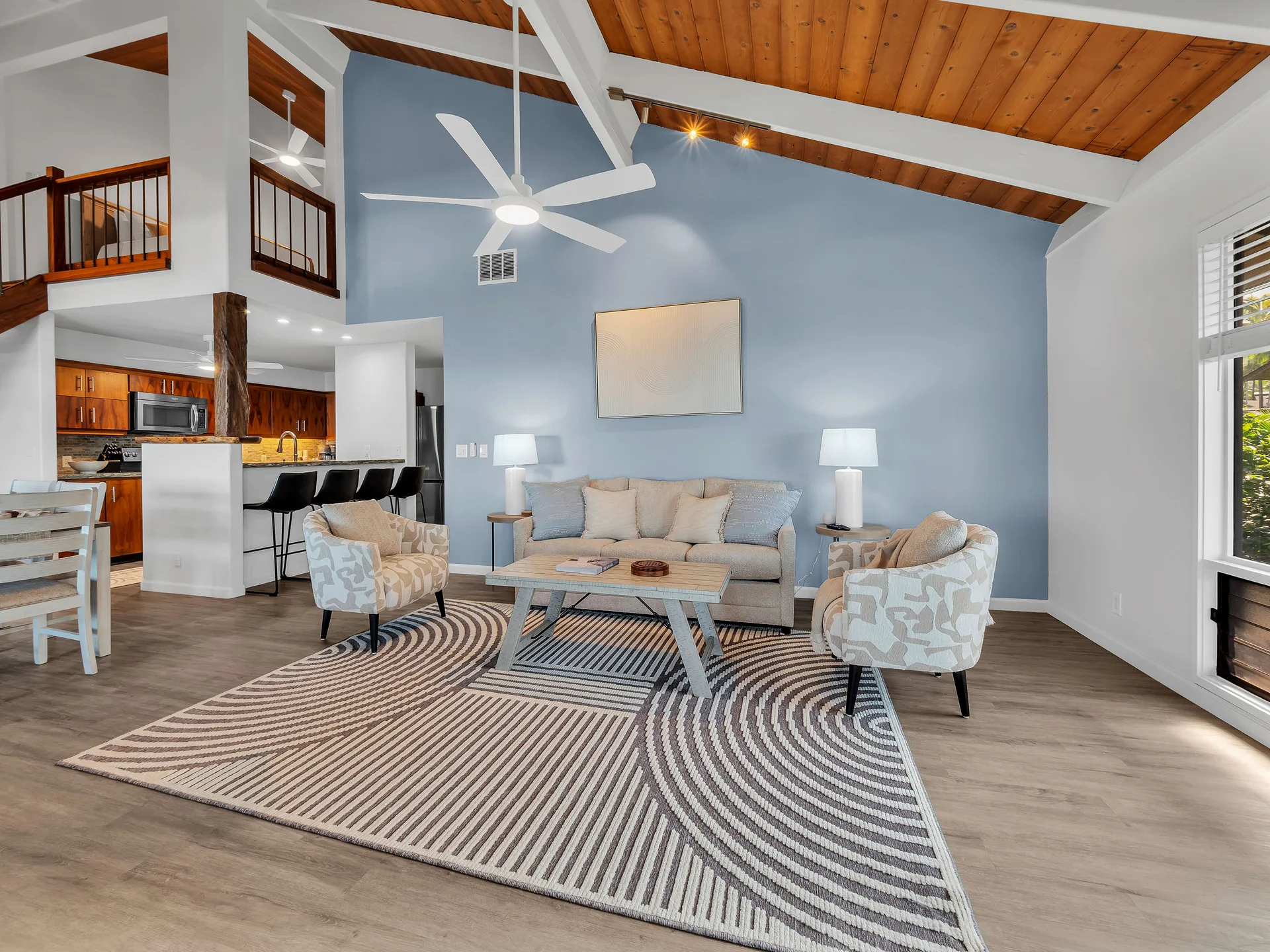 Open living room showing loft and vaulted ceiling
