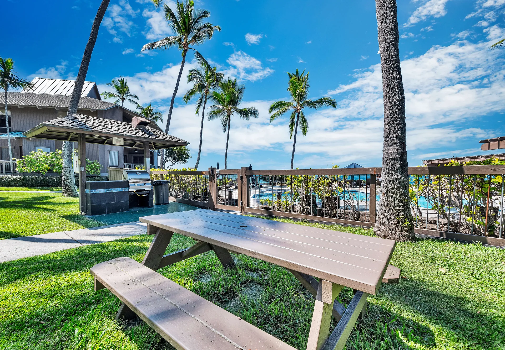 Picnic area by pool with palms