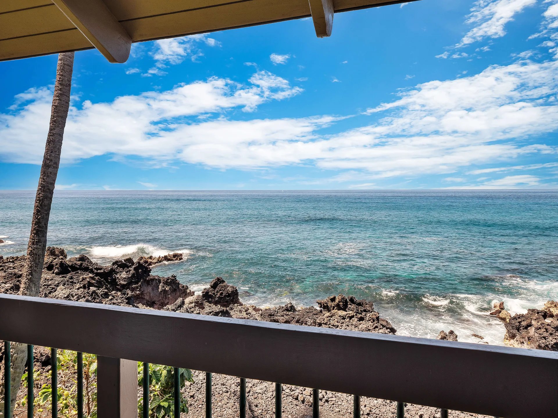 Ocean view from the lanai with lava rocks and blue water
