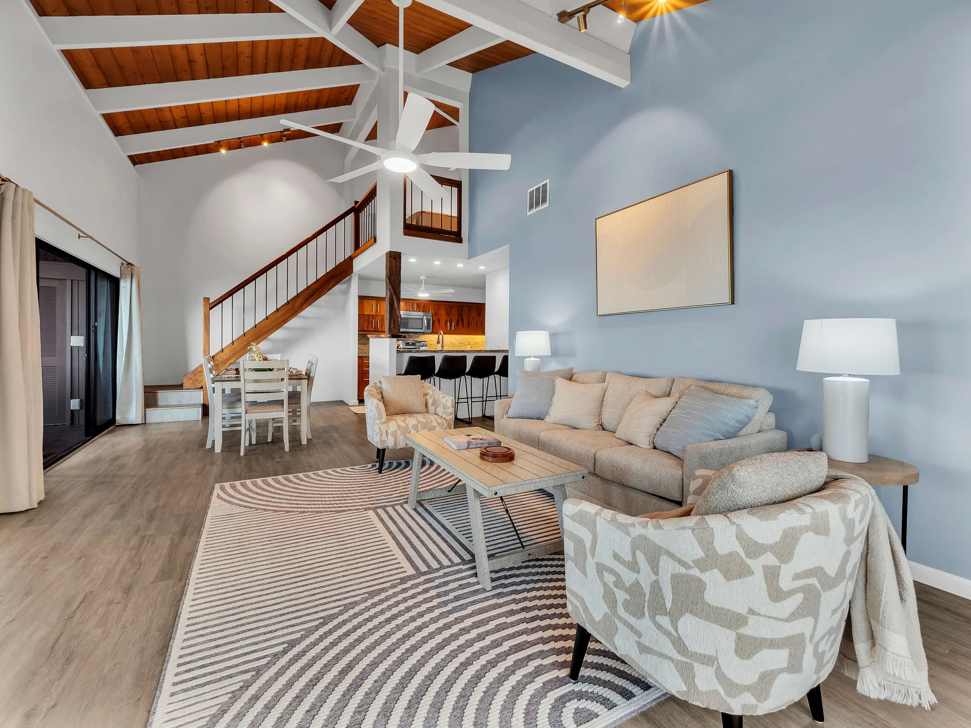Living room with blue accent wall and staircase